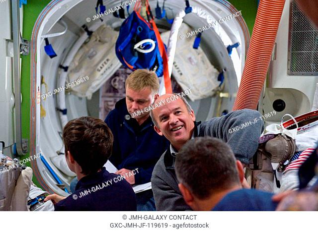 Astronaut Jeffrey Williams (facing camera), Expedition 21 flight engineer and Expedition 22 commander; cosmonauts Maxim Suraev (background)