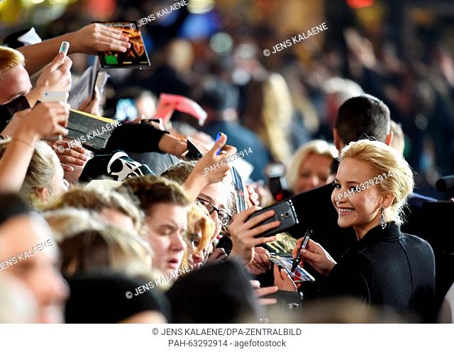Actress Jennifer Lawrence arrives and gives fans autographs at the world premeiere of The Hunger Games: Mockingjay Part 2 at the Cinestar cinema in Berlin