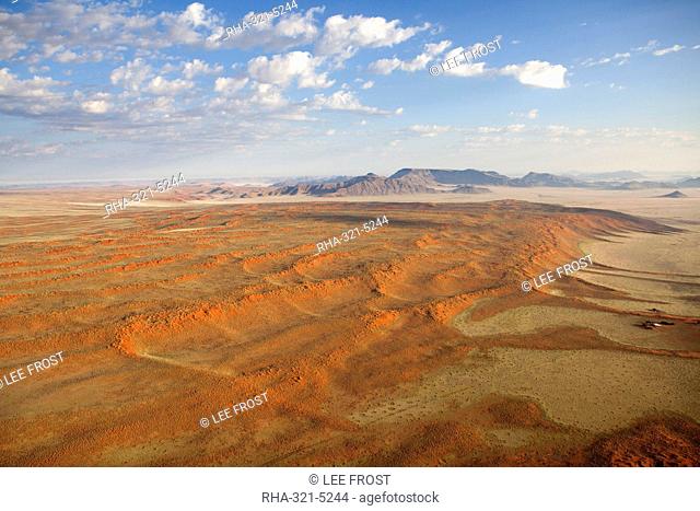 Aerial view from hot air balloon over magnificent desert landscape of sand dunes, mountains and Fairy Circles, Namib Rand game reserve Namib Naukluft Park