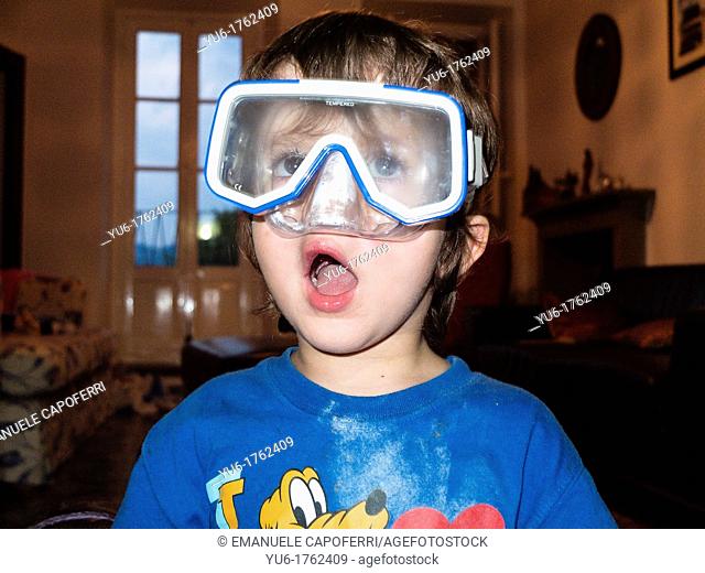 Child plays with a diving mask