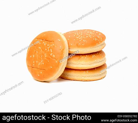 stack of baked round burger buns isolated on white background, close up