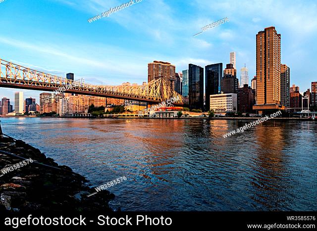 New York City / USA - JUL 31 2018: Queensboro Bridge and midtown view from Roosevelt Island at sunrise