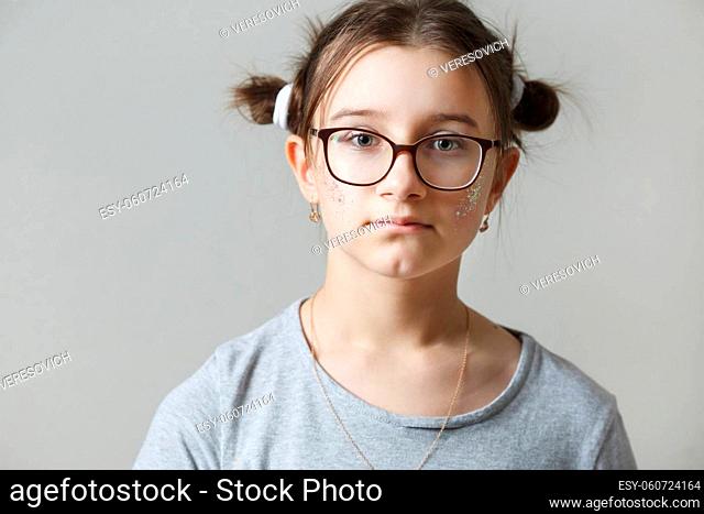 Studio portrait of a teenage girl wearing glasses