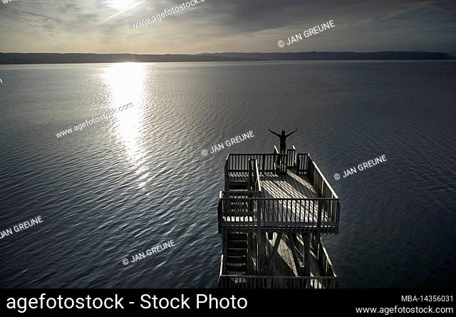 Woman on diving tower at lido Utting am Ammersee, Bavaria, Germany
