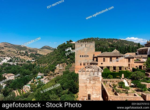 View of the Nasrid Palaces (Palacios Nazaries) in Alhambra, Granada on a beautiful summer day, Spain, Europe, clear blue sky