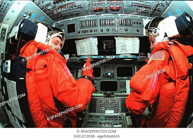 11/06/1998 --- STS-88 Mission Commander Robert D. Cabana left and Pilot Frederick W. Rick Sturckow right take their seats in the flight deck inside orbiter...