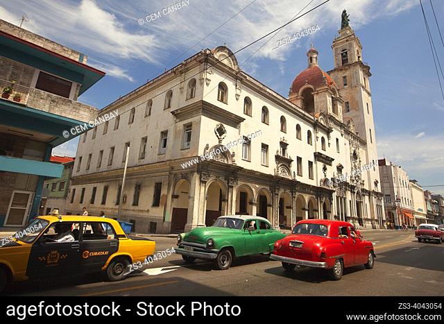 Old American cars used as taxi in front of the Iglesia y Convento del Carmen-Church and Convent of Carmen in Vedado district, La Habana, Cuba, West Indies