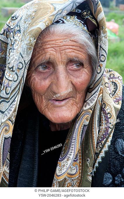 Elderly Armenian woman who sells woven and knitted souvenirs to tourists visiting the ancient gravestones at Noratus