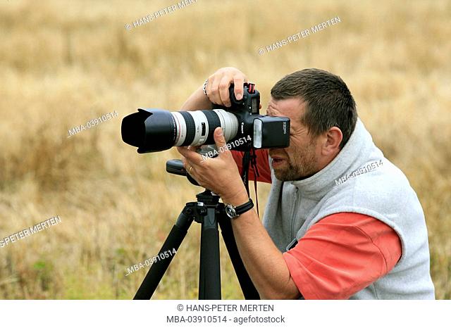 Photographer, camera, lightning, telephoto lens, tripod, photographs