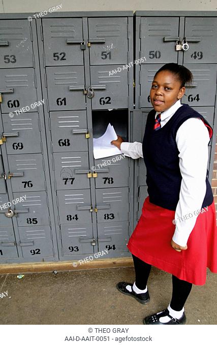 School girl using locker, St Mark's School, Mbabane, Hhohho, Kingdom of Swaziland