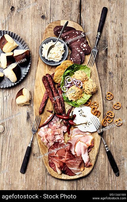 Southern German snack board with different kinds of sausages and Obazda