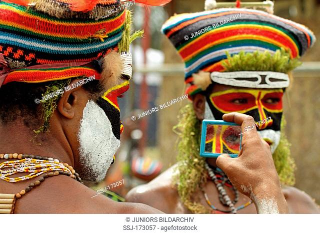 Tribesman with painted face and in traditional costume at the annual tribal gathering, Goroka, Papua New Guinea
