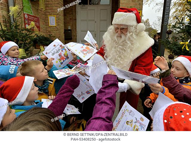 Santa hands out sweets to Bredereiche Elementary School pupils for the opening of the Christmas Post Office in Himmelpfort, Germany, 06 November 2014