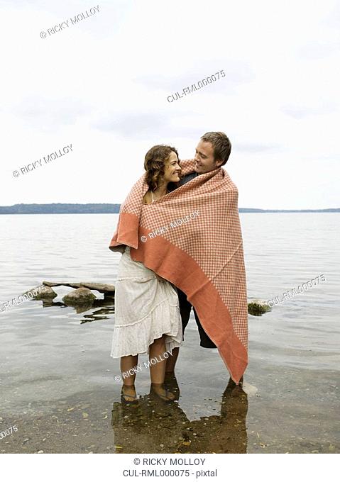Man and woman standing in shallow water