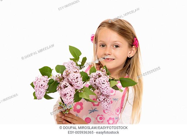 Happy little girl with long hair wearing summer dress and holding lilac flowers. Isolated on white background