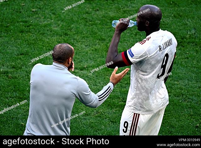 Belgium's assistant coach Thierry Henry and Belgium's Romelu Lukaku react during a second game of the group stage (group B) at UEFA Euro 2020 championships...