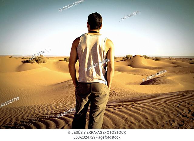 Lonely man in M'Hamid desert, Morocco