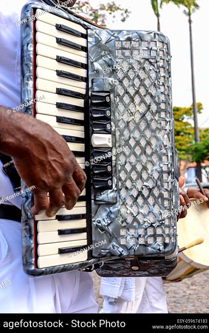 Musician playing accordion at popular religious festival in the city of Sabara, interior of the state of Minas Gerais, Brazil