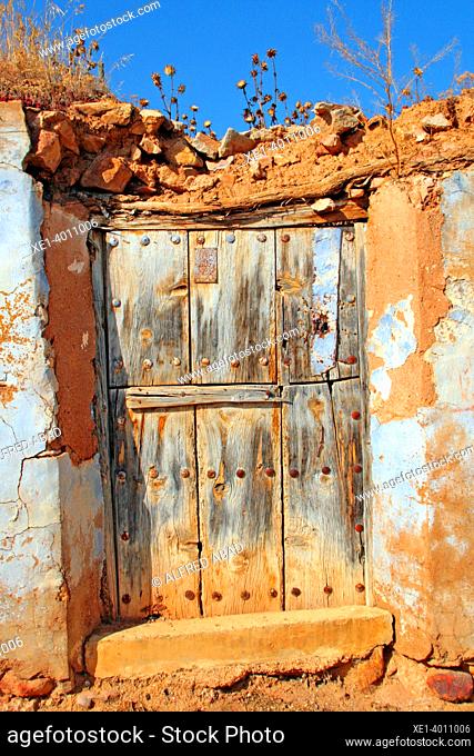 wooden door of house with ruins, Uset, Camp de Daroca, Zaragoza, Spain