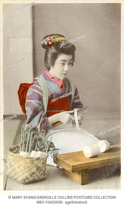 Japan - Geisha girl preparing (cutting) daikon (white radish), possibly for takuan or bettarazuke dishes