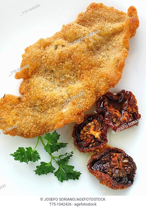Breaded steak with sundried tomato and olive oil