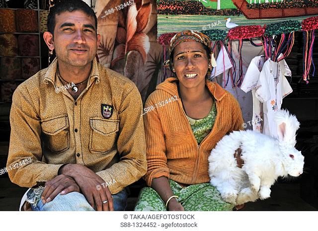 Indian couple sitting together with rabit in Vashist. Manali, Himachal Pradesh, India