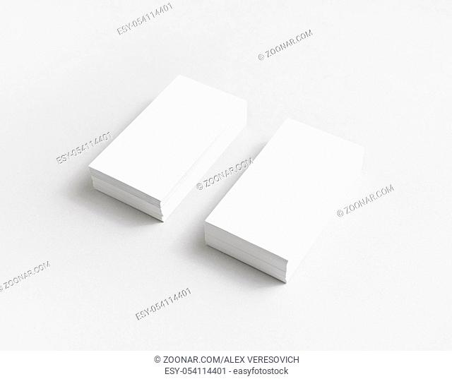 Photo of blank white paper business cards with soft shadows. Mock up for branding identity for designers