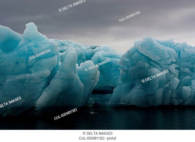 Blue iceberg and storm clouds, Burgerbukta, Spitsbergen, Svalbard, Norway