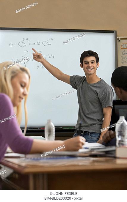 Student explaining formula in classroom