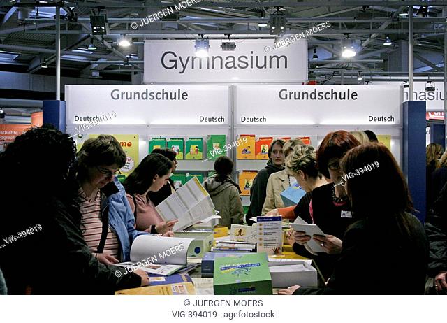 22.02.2006, Germany, Niedersachsen, Hanover: Humans stand at an exhibition booth with books, didacta. - Hannover, Niedersachsen, GERMANY, 22/02/2006