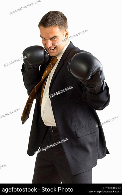 Angry businessman in black boxing gloves, isolated on white in studio. Looking at camera