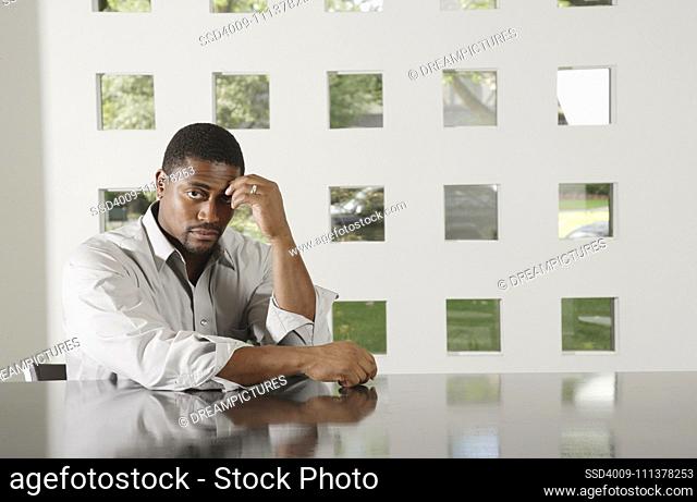 African man sitting at table