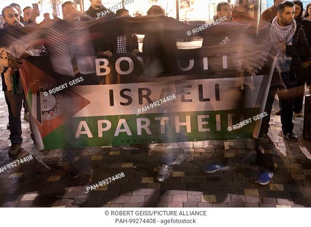 Palestinians during rally against Israel. Banner of Palestinian flag, writing ""Boycott of Israeli apartheid"". 30.01.2018 | usage worldwide