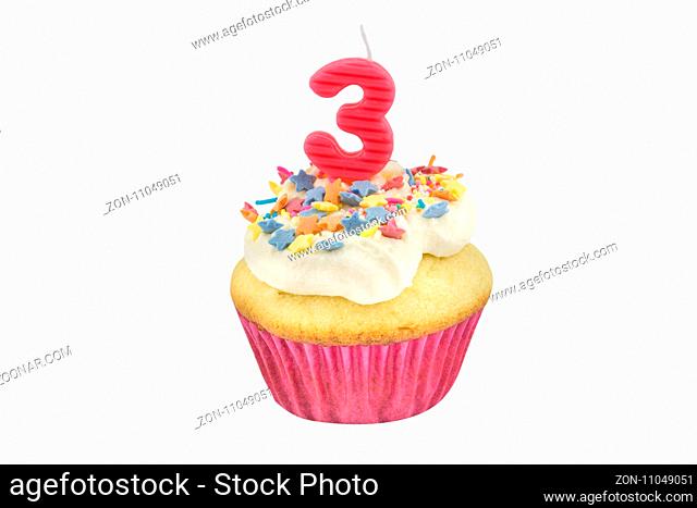 Happy birthday cup cake with star sprinkles and number 3 pink candle on white table with pink background - Birthday celebration background for a little girl -...
