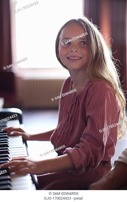 Smiling Girl’s hands on piano