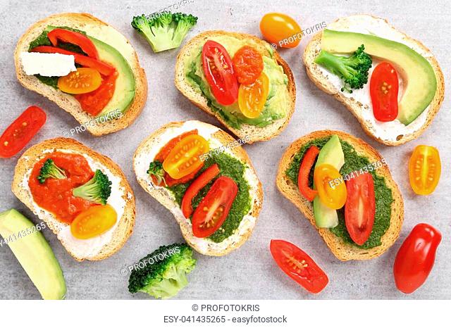Colorful vegetarian sandwiches on a gray ceramic background. Healthy food