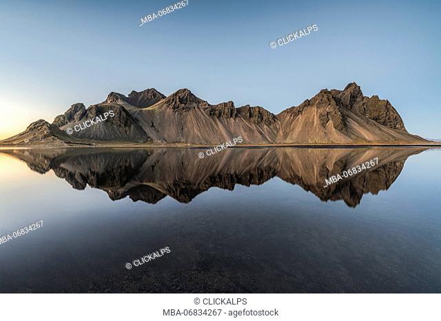 Stokksnes, Hofn, Eastern Iceland, Iceland. Vestrahorn mountain mirrors in the waters of the Stokksnes bay