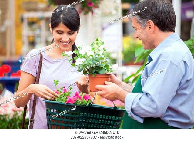 Woman buying plants in garden center