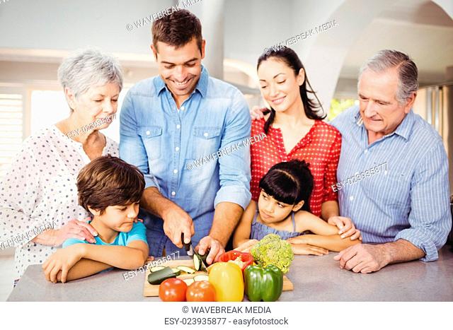 Happy man with family by kitchen table