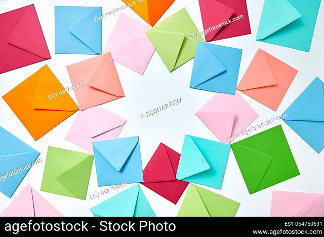 Greeting cards of handcraft multicolored envelopes frame on a light background with copy space