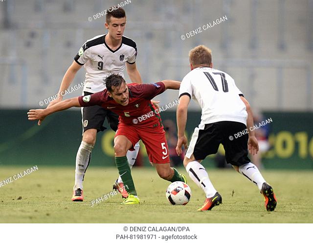 Portugal's Yuri Ribeiro (c) competes for the ball with Austria's Arnel Jakupovic (l) and Fabian Gmeiner (r), during the UEFA Under-19 European Championship...