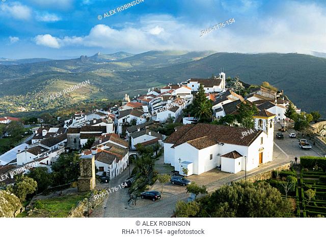 The 15th century parish church and medieval town from the 13th century castle with the Serra de Sao Mamede mountains behind, Marvao, Alentejo, Portugal, Europe