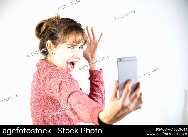 Extremely joyful woman at the sight of her new smartphone