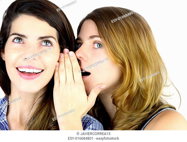Portrait of young woman telling a secret to another woman