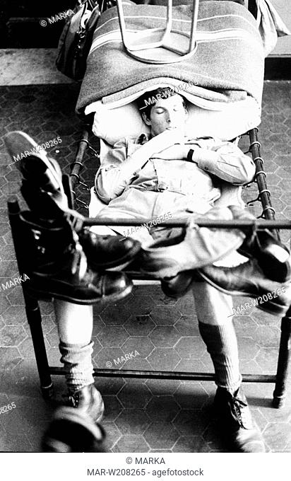 soldato dell'esercito italiano si riposa su una branda, italia anni 70