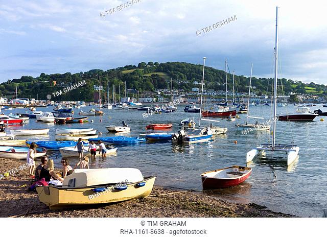 Boats in the harbour and family group on beach at coastal resort of Teignmouth in South Devon, England, United Kingdom, Europe