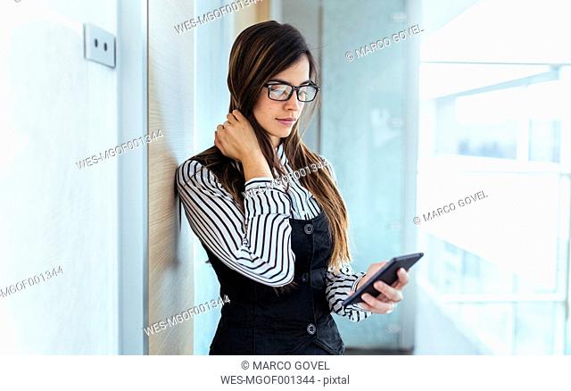 Young businesswoman looking at her smartphone
