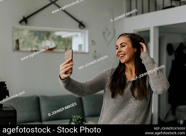 Smiling woman taking selfie