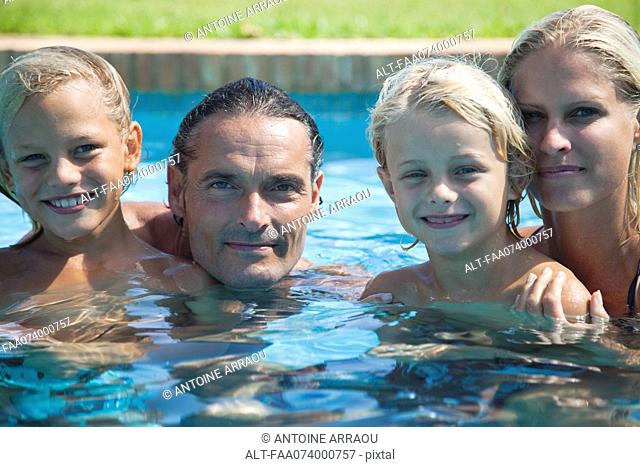 Family in swimming pool, portrait