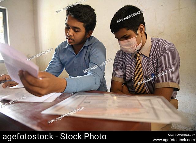 Visually impaired students answer questions during the higher secondary exam with the assistance of a ""scribe"" at Sukhamoy HS School
